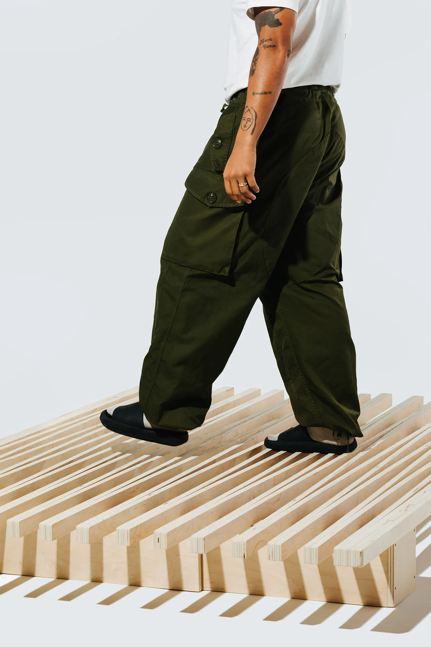 A person walking across the Accordion bed frame by Quagga Designs