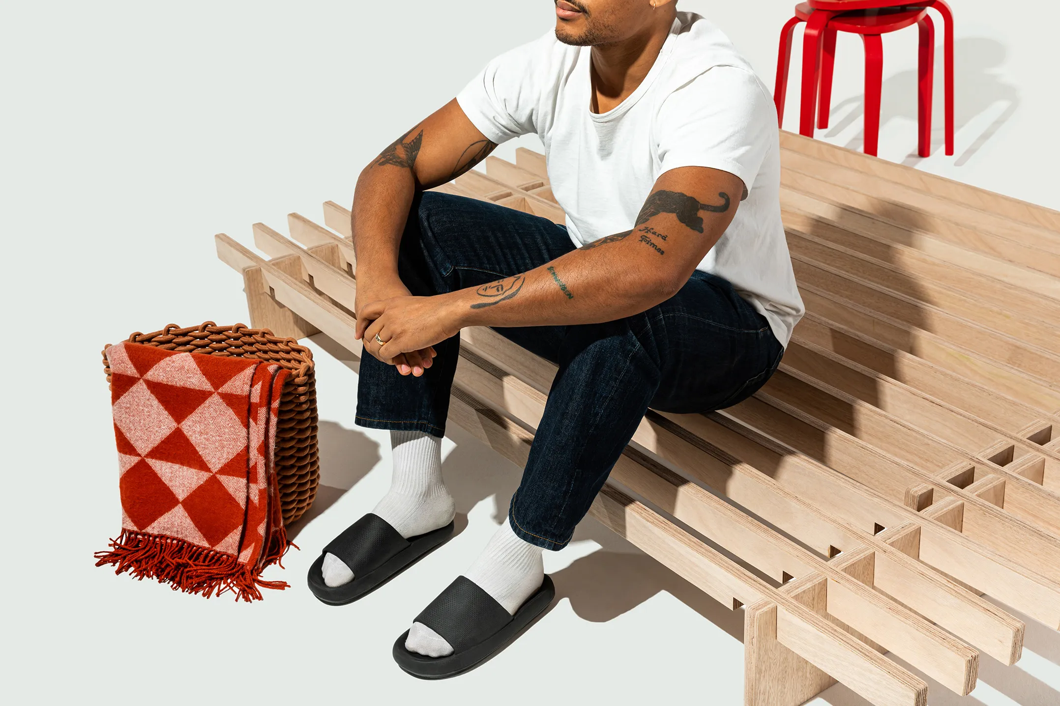 A person sitting on the No Fuss Plus bed frame by Quagga Designs.